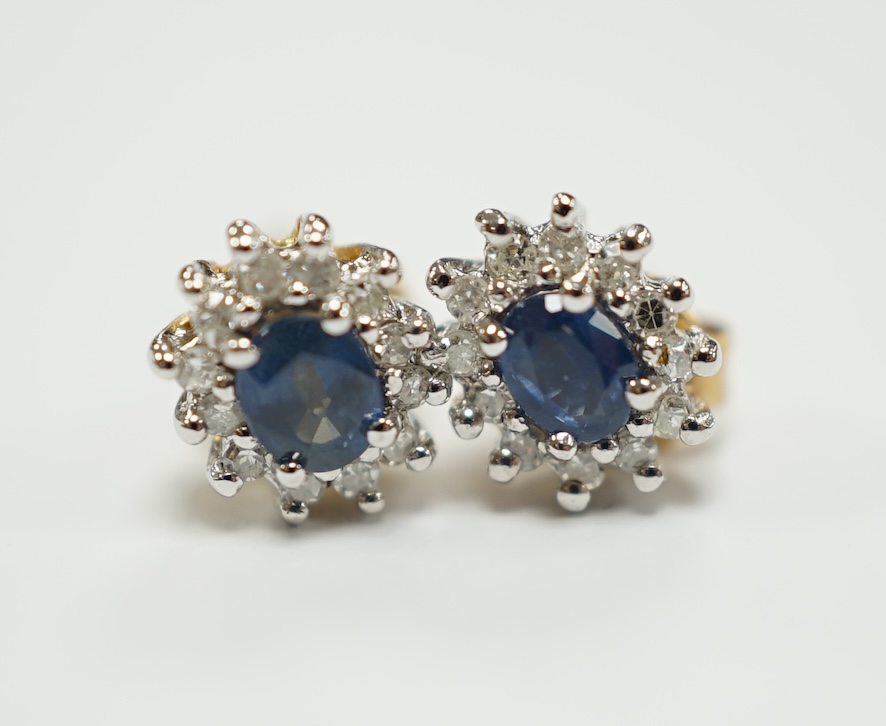 A pair of yellow metal, sapphire and diamond set oval cluster ear studs, 7mm, gross weight 1.3 grams.